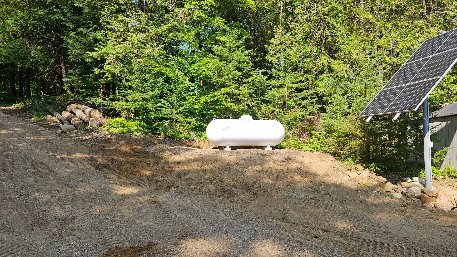 Ground-mounted solar array at a wooded remote property